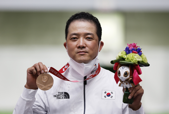 Park Jin-ho celebrates his men's 10-meter air rifle standing class one bronze medal on the podium at Asaka Shooting Range in Tokyo on Monday. [REUTERS/YONHAP]