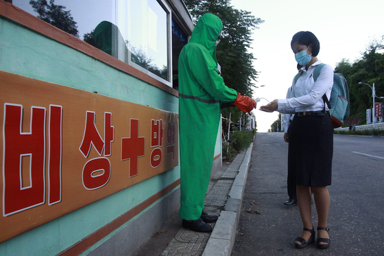 A health official conducts anti-epidemic work at the entrance of Pyongsong city in South Pyongan Province, North Korea on Wednesday. [AP/YONHAP]