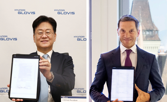 Kim Jung-hoon, CEO of Hyundai Glovis, left, and Jose Maria Larocca, executive director and co-head of oil trading at Trafigura, pose for photos on Thursday after signing a 10-year gas shipping contract in their offices in Korea and Switzerland. [HYUNDAI GLOVIS]