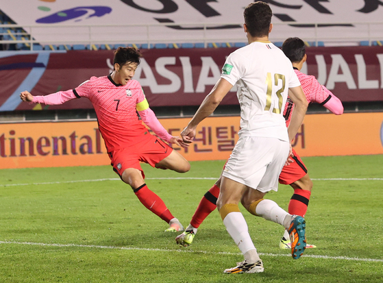 Son Heung-min, left, scores Korea's second goal to clinch a 2-1 victory against Syria in the third round of qualifiers for the 2022 Qatar World Cup at Ansan Wa Stadium in Ansan, Gyeonggi on Thursday. [YONHAP]