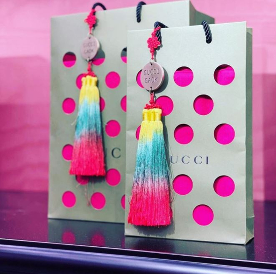 Gucci Gaok's paper bags feature traditional Korean norigae hanging from the handle. [SCREEN CAPTURE]