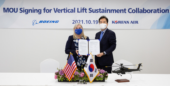 Maria Laine, Boeing Defense, Space and Security’s vice president of international strategic partnerships, left, poses with Lee Soo-keun, Korean Air executive vice president, after signing an agreement to cooperate to develop vertical lift technology for military rotorcraft at the Seoul International Aerospace and Defense Exhibition 2021 at Seoul Airbase in Gyeonggi on Tuesday. [KOREAN AIR]