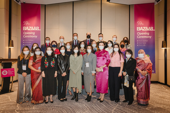 Ambassadors and their spouses of nearly 20 countries including Azerbaijan, Belgium, Georgia, Ghana, Hungary, Nicaragua, Nigeria and Mexico. The spouse of the ambassador of Azerbaijan and representative of Ambassadors Spouses Association of Seoul, Konul Teymurova, third from front right; president of Seoul International Women's Association (SIWA), Veronica Koon, fifth from right, joined by other members; and Song Hyeon-ok, sixth from front right, spouse of the Seoul mayor, celebrate the opening of the 59th SIWA & Diplomatic Community Online Bazaar at the Fairmont Ambassador Hotel in western Seoul on Tuesday. The online bazaar will be open through Nov. 21 and all proceeds will go toward supporting local Korean charities. [SIWA]