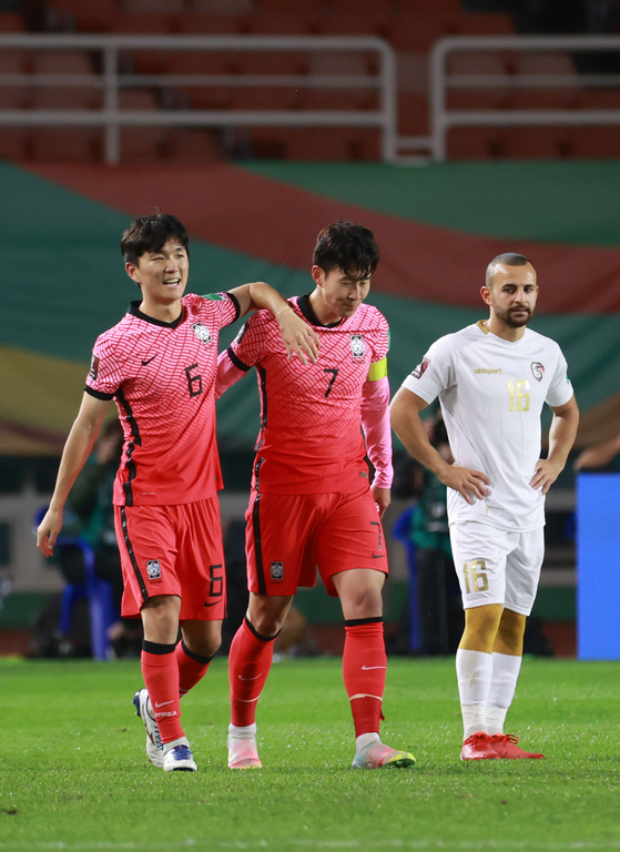 Hwang In-beom, left, celebrates with Son Heung-min after scoring Korea's first goal against Syria in the third round of qualifiers for the 2022 Qatar World Cup at Ansan Wa Stadium in Ansan, Gyeonggi on Oct. 7. [YONHAP]