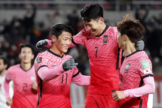 Hwang Hee-chan, left, Son Heung-min, center, and Kim Jin-su celebrate at a 2022 FIFA World Cup qualifier match between Korea and United Arab Emirates on Thursday after scoring Korea's first goal at Goyang Stadium in Goyang, Gyeonggi. [NEWS1]