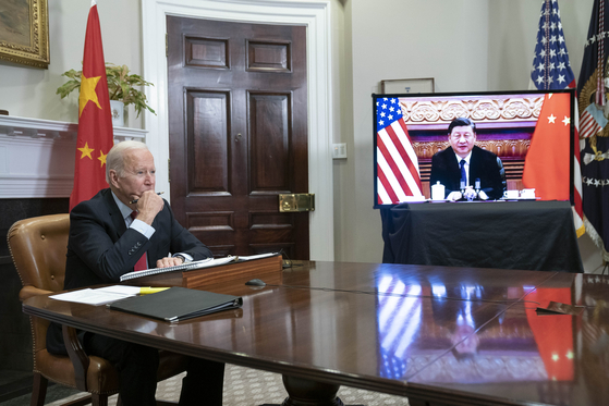 U.S. President Joe Biden listens during a virtual summit with Chinese President Xi Jinping in the Roosevelt Room of the White House in Washington Monday. [UPI/YONHAP]
