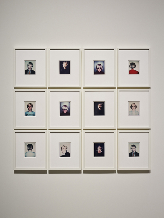 Polaroid photos taken by Warhol, showing him wearing his signature ″fright wig″ and posing in many ways [FONDATION LOUIS VUITTON & THE ANDY WARHOL FOUNDATION FOR VISUAL ARTS INC.]