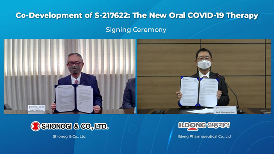 Yun Woong-sup, right, CEO of Ildong Pharmaceutical, and Isao Teshirogi, CEO of Shionogi, pose for a photo after signing an agreement online to codevelop an oral Covid-19 treatment. [ILDONG PHARMACEUTICAL]