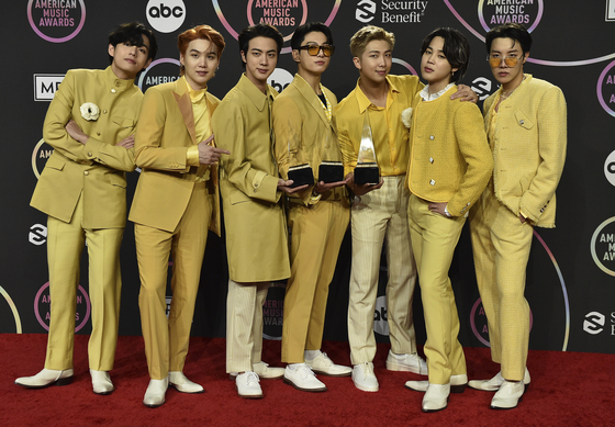 BTS collects three awards at the American Music Awards on Sunday at the Microsoft Theater in Los Angeles, including Artist of the Year, Favorite Pop Duo or Group and Favorite Pop Song for "Butter." [AP/YONHAP]