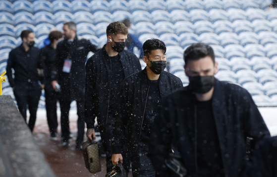 Tottenham Hotspur's Son Heung-min walks next to the pitch with teammates at Turf Moor in Burnley, England, on Sunday as snow falls before the match. Tottenham's match against Burnley was called off due to heavy snowfall. [REUTERS/YONHAP]