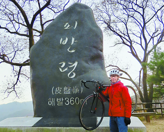 A visitor to Piballeyong poses in front of a name stone [KIM HONG-JUN]