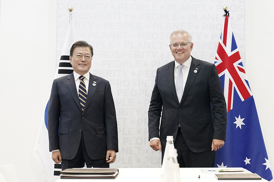 Korean President Moon Jae-in, left, poses for a photo with Australian Prime Minister Scott Morrison at a bilateral summit on the sidelines of the G20 summit in Rome on Oct. 31. [BLUE HOUSE] 