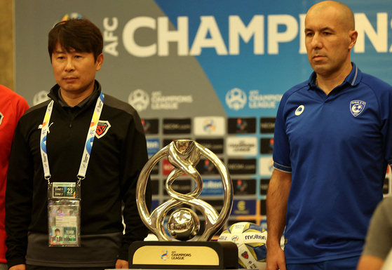 Pohang Steelers coach Kim Gi-dong, left, and Al-Hilal coach Leonardo Jardim pose with the trophy on the eve of the AFC Champions League final on Nov. 22 at the Crowne Plaza Hotel in Riyadh, Saudi Arabia. [AFP/YONHAP]