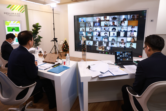Financial Supervisory Service Governor Jeong Eun-bo, center, during a video conference with reporters Tuesday [FINANCIAL SUPERVISORY SERVICE]