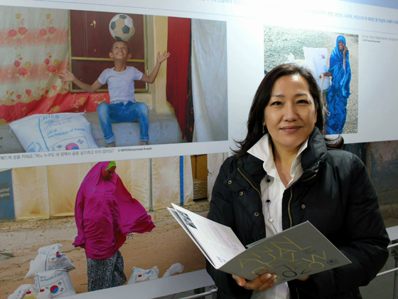 Marian Yun pose in front of the World Food Programme photo exhibition held near the National Museum of Korea in Yongsan, Seoul. [WORLD FOOD PROGRAMME]