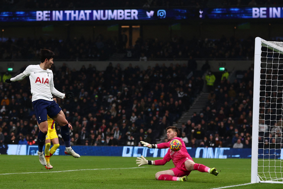 Tottenham Hotspur striker Son Heung-min, left, shoots to score their third goal past Crystal Palace goalkeeper Jack Butland during the match between Tottenham Hotspur and Crystal Palace at Tottenham Hotspur Stadium in London on Sunday. [AFP/YONHAP]