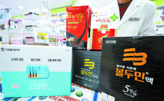 Hair loss treatment medications in a drug store in Seoul. [YONHAP]