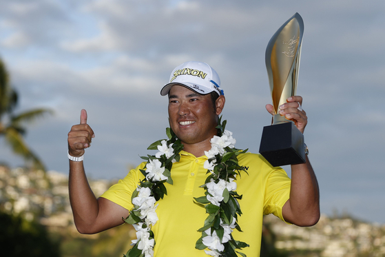 Hideki Matsuyama of Japan celebrates with the trophy after winning in a one-hole playoff against Russell Henley of the United States during the final round of the Sony Open in Hawaii at Waialae Country Club on Sunday. [AFP/YONHAP]