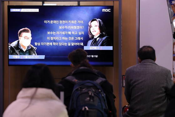 People watch a much-hyped broadcast of MBC’s “Straight” revealing the contents of phone calls recorded between Kim Keon-hee, wife of People Power Party presidential candidate Yoon Suk-yeol, and a reporter of a liberal media outlet Sunday evening at Seoul Station, central Seoul. [NEWS1]