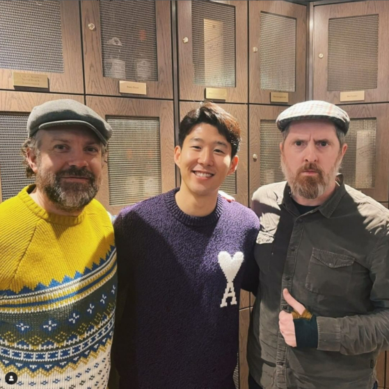 Son Heung-min, center, poses with “Ted Lasso” stars Jason Sudeikis, left, and Brendan Hunt in a photo posted to the footballer's Instagram on Sunday. “Ted Lasso,” an award-winning comedy about an American football coach hired to coach a Premier League football club, recently signed a licensing deal with the Premier League to use its logos, kits and archive footage. Son’s photo, captioned “if you know you know!!,” prompted rumors the Korean star could be making a cameo in the upcoming third season. [SCREEN CAPTURE]