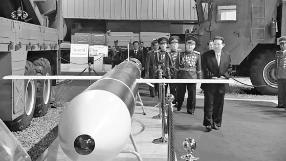 Footage run by the North's state-run Korean Central Television on Jan. 12 shows North Korean leader Kim Jong-un viewing what is suspected to be a cruise missile similar to the one tested on Tuesday at a special defense exhibition marking the 76th anniversary of the founding of the ruling Korean Workers' Party in Pyongyang. [YONHAP]