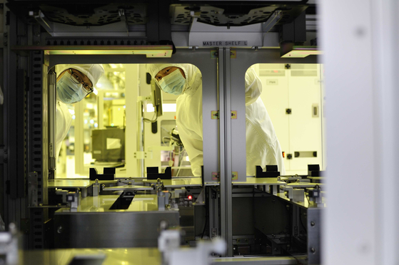 Researchers at SK hynix check chip manufacturing equipment at a factory in Icheon, Gyeonggi. [SK hynix]
