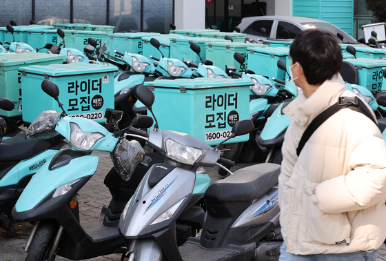 Motorcycles are parked in front of a Baemin rider center in Seoul on Tuesday. The cost of restaurant deliveries is expected to increase as food delivery platforms including industry leader Baemin and Coupang Eats wind down promotional discounts. [YONHAP]