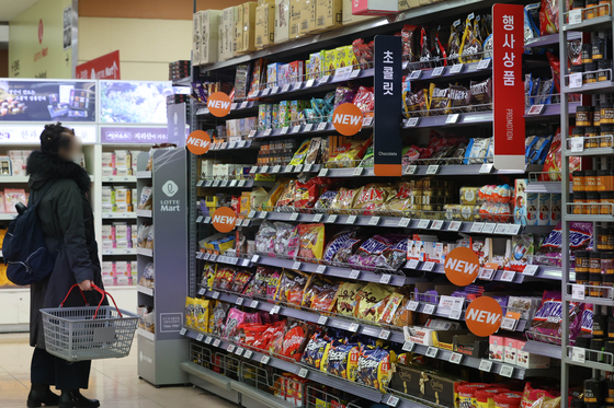 A customer stands in the chocolate aisle at a retail store in Seoul on Tuesday. Valentine’s Day has passed, and the price of chocolate is expected to rise as the price of cacao in the global market has reached its highest since November 2020 due to severe drought in West Africa including Cote d’lvoire, where cacao is produced. [YONHAP]