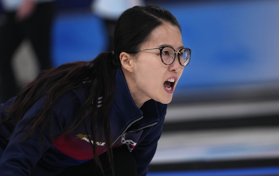 Kim Eun-jung directs her teammates during a women's curling match against Denmark at the 2022 Winter Olympics on Wednesday. [AP/YONHAP]