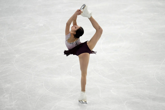 You Young performs a Biellmann spin in the women's free skate program during the figure skating competition at the 2022 Winter Olympics on Thursday. [AP/YONHAP]