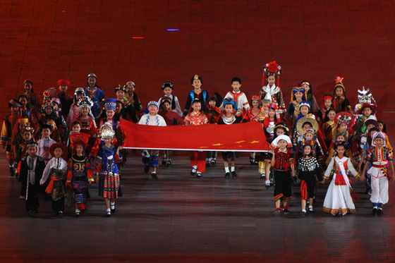 Children from 56 ethnic groups in China carry the Chinese flag during the opening ceremony of the 2008 Beijing Summer Olympics. [AFP]