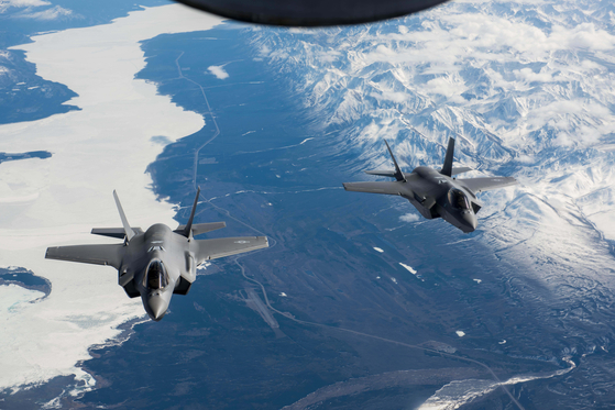 Two F-35A stealth fighter jets fly over Alaska in this photo from April 21, 2020, provided the U.S. Indo-Pacific Command. [U.S. INDO-PACIFIC COMMAND]