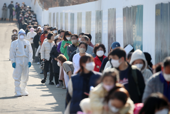 People wait in line to get tested for Covid-19 at a screening center in Daegu on Wednesday.