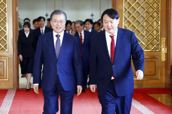 President Moon Jae-in, left, walks beside then-prosecutor general Yoon Suk-yeol in the Blue House on July 25, 2019. Yoon was elected president on Thursday. [YONHAP]