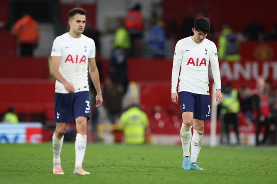 Tottenham Hotspur's Sergio Reguilon, left, and Son Heung-min look dejected after a match against Manchester United at Old Trafford in Manchester on Saturday. [REUTERS/YONHAP]
