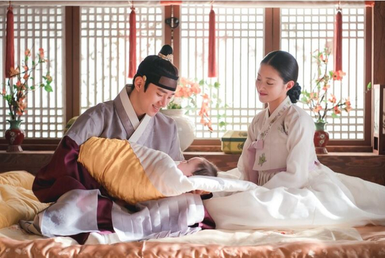 Deok-im, right, gives birth to King Jeongjo's first son, Crown Prince Munhyo in 1782, and received the highest rank 'bin' of the eight-rank gungnyeo system. The king gave her the hanja ui, meaning appropriate. [MBC]