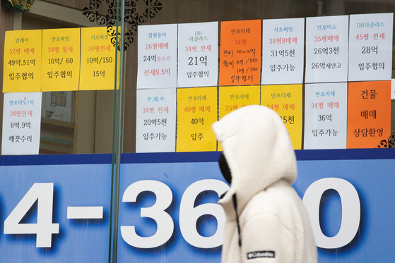 Prices of apartments on sale and for rent are posted at a real estate agency in Seoul. [NEWS1]