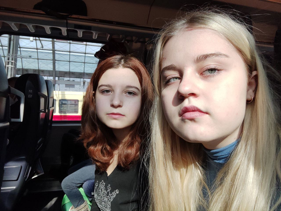 Galyna Solovei's eldest daughters Maria, 16, and Sasha, 14, on a train from Berlin to Amsterdam as they flee Ukraine following the outbreak of war between Russia [GALYNA SOLOVEI]