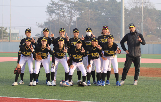 Kim Ra-kyung, bottom right, poses with the Just Do Baseball team and coach Kim Byeong-geun, far right, after beating a men's amateur baseball team for the first time at Hwaseong Dream Park Baseball Field in Hwaseong, Gyeonggi on Dec. 13, 2021. [YONHAP]