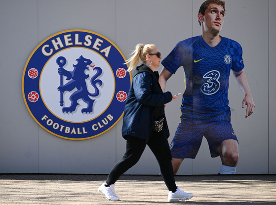 A pedestrian walks past Chelsea's stadium Stamford Bridge in London on March 18. [AFP/YONHAP]