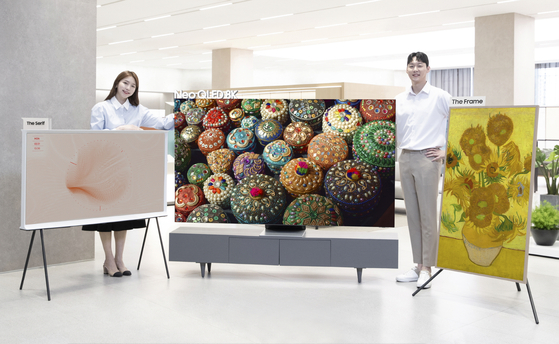 Models pose with Samsung Electronics’ 2022 TV lineup, which includes Serif, left, Neo OLED 8K, center, and The Frame, right. Samsung has remained in the top spot of the global TV market for 16 years. [SAMSUNG ELECTRONICS]