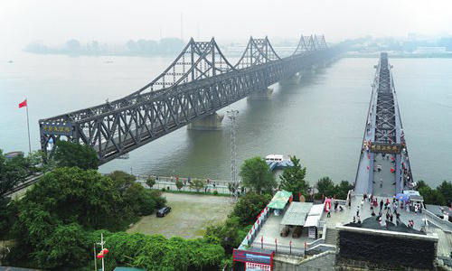 The Friendship Bridge in Dandong, right, connects rail lines between China and North Korea. The North recommenced overland rail operations in January this year, partially lifting a self-imposed blockade on border trade that has lasted almost 2 years. [AP]