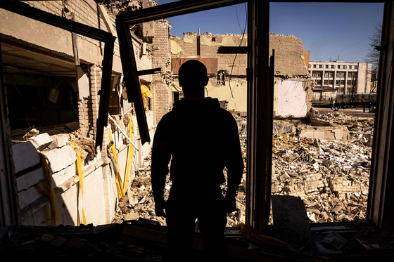 A man stands inside of what used to be a school in the city of Zhytomyr, northern Ukraine, on March 23. [AFP/YONHAP]