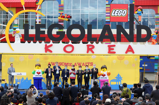 Second from left: Legoland Resorts Group Chief Operating Officer John Jakobsen, CEO of Merlin Entertainments (which operates the theme park) Nick Varney and Gangwon Governor Choi Moon-soon pose for a photo to celebrate the completion of Chuncheon Legoland Korea Resort on March 26, in front of the amusement park in Chuncheon, Gangwon. The resort will open on May 5, Korea's Children's Day, as the 10th Legoland in the world. [LEGOLAND KOREA RESORT] 