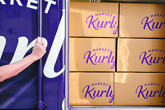 Market Kurly's deliveries are stacked in a delivery truck. [KURLY]