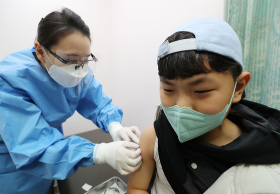  A boy receives a Covid-19 vaccine shot at a hospital in Gwangju on Thursday, as the government began administering Pfizer shots to children between the ages of 5 and 11. [YONHAP]