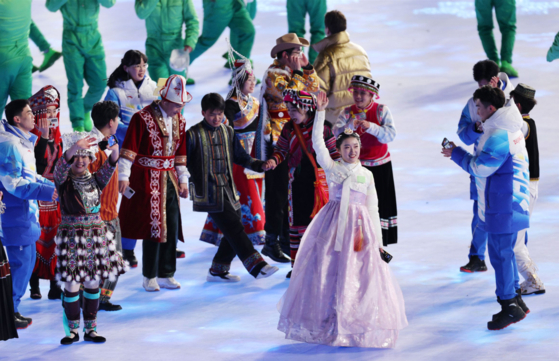 Among the representatives of ethnic minorities in China carrying the national flag of the country at the opening ceremony of the Beijing Winter Olympics, there is a woman who appears to be wearing habok, traditional Korean clothing. [SCREEN CAPTURE] 