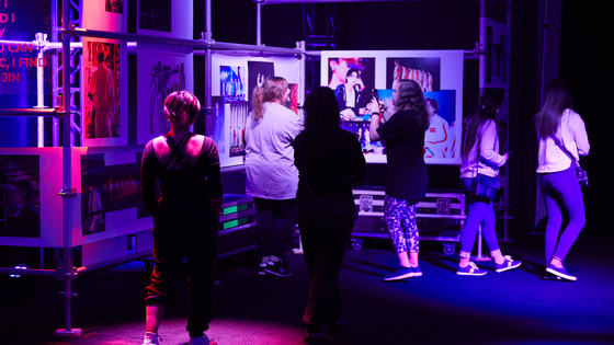 Fans check out behind-the-scenes photos of BTS members preparing for "BTS Permission to Dance On Stage - Las Vegas" concert at the "Behind the Stage: Permission to Dance" exhibition in Las Vegas. [HYBE]