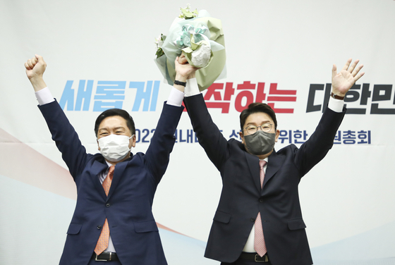 People Power Party Rep. Kweon Seong-dong, right, cheers after being elected as the party's new floor leader, succeeding PPP Rep Kim Gi-hyeon, left, at the National Assembly in Yeouido, western, Seoul Friday. [JOINT PRESS CORPS]