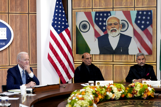 In a virtual meeting with Indian Prime Minister Narendra Modi, U.S. President Joe Biden, left, says he looks forward to seeing him in Japan in May at a meeting of leaders of the Quadrilateral Security Dialogue, or Quad, at the White House in Washington Monday. Biden’s first trip to Asia could be an opportunity for a visit to Korea for a summit with President-elect Yoon Suk-yeol. [AP/YONHAP]